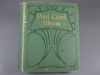 A green bound postcard album