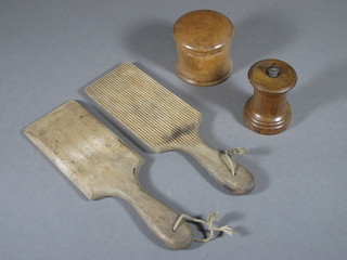 A pair of wooden butter pats, a turned wooden mill and a  wooden jar and cover 3"