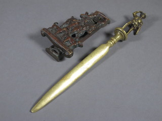 A bronze paper knife the handle decorated a standing life  boatman together with a metal door knocker decorated John Peel