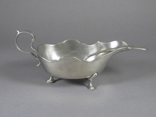 A large pewter sauce boat and a fiddle pattern sauce ladle