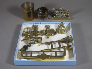 A miniature brass fire curb 7", a 3 piece miniature brass fireside companion set, pair of miniature brass porter's wheels and other  items