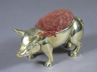 A 19th Century brass pin cushion in the form of a standing pig 4"
