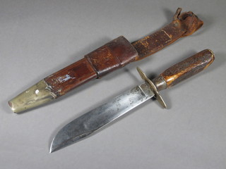 A Bowie knife with staghorn handle, the 7" blade marked  WMCORE and contained in a leather scabbard