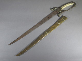 An Eastern sword with 18" blade, ivory grip and brass scabbard