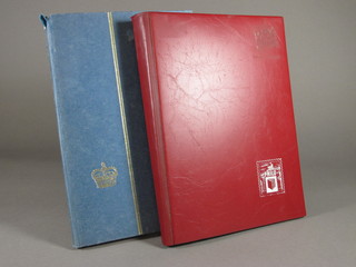 A blue stock book of stamps and a red stock book of stamps