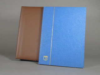 A brown loose leaf album of Jersey stamps and a blue stock book  of stamps