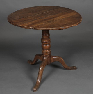 A mahogany snap top tea table, raised on a gun barrel turned  column 30"