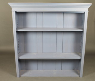 A blue painted bookcase with moulded cornice fitted adjustable shelves 48"