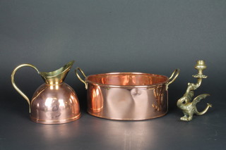 An oval copper twin handled planter 10", a brass candlestick in the form of a griffin 8" and a brass jug 7"