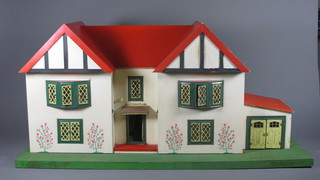 A 1930's dolls house complete with garage 36"