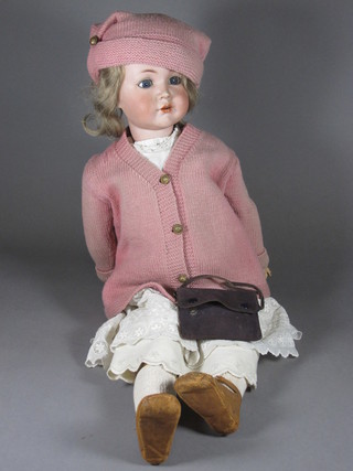 A Simon & Halbig porcelain headed doll with open and shutting eyes and open mouth with teeth, the head incised KR and Halbig  117, crack to back of neck,  ILLUSTRATED