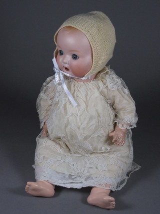 An Armand Marseille porcelain headed doll, the head incised Germany AM 518/4K, with open and shutting eyes and open  mouth with teeth, 16"