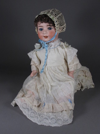 A German porcelain headed doll, the head incised Herbert Koppelsdorf 300.7 Germany, with open and shutting eyes, open  mouth with movable tongue 22"