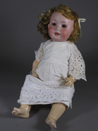 A porcelain headed doll with open and shutting eyes and open  mouth with 2 teeth, the head incised PM914 German 8, 18"