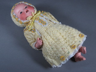 An Armand Marseille porcelain headed baby doll, the head  incised AM Germany 351 with open eyes and open mouth with 2  teeth, 11"