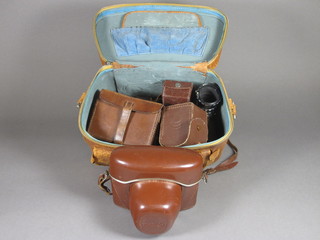 An Exakta camera, a Palomar telescopic 1:2.8 F=135mm lens,  2 Westminster x2 converter lenses, a Soligor F=35mm 1:3.5  lens and a pair of Prismoid Aero binocular club binoculars etc,  contained in a leather carrying case