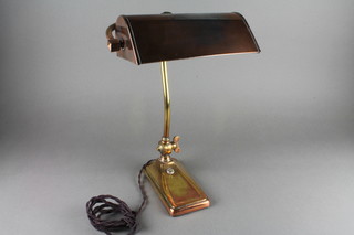 A copper and brass bank lamp