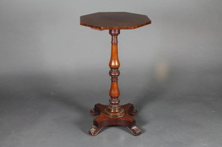 A William IV octagonal mahogany table raised on a turned  column with triform base and paw feet 17"