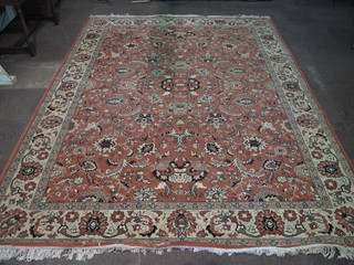 A peach ground and floral patterned machine made Persian style  rug 127" x 94"