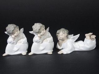 A Lladro figure of a reclining Angel 5" and 2 other Lladro  figures of seated Angels 5"