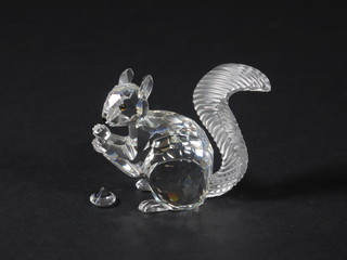 A Swarovski figure of a seated squirrel with nut 2", boxed,