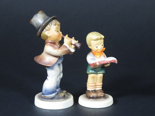 A Hummel Club Members figure 2000/2001 - ABC Honours  Student 4" and 1 other of a standing boy playing a musical instrument 4 1/2"