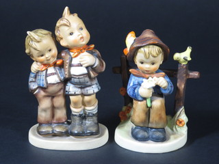 2 Hummel figures - seated boy by a fence with flower and bird  4" and 2 boys