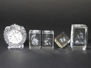 4 square glass paperweights with etched decoration to the centre and a glass cased clock