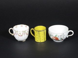 A Continental porcelain cup with floral decoration, a crescent china cup with floral decoration - chip to base and a yellow  glazed miniature cup