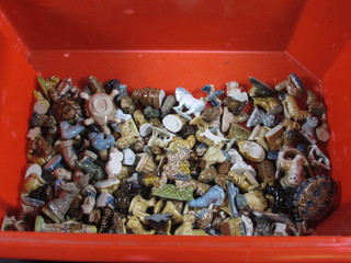 A red crate containing a collection of Wade Whimsies