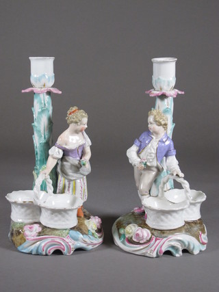 A pair of 19th Century Continental porcelain candlesticks  decorated figures standing by baskets, 1 f and r, 8 1/2"