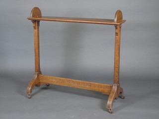 A Victorian aesthetic movement oak book trough on square  supports 42"
