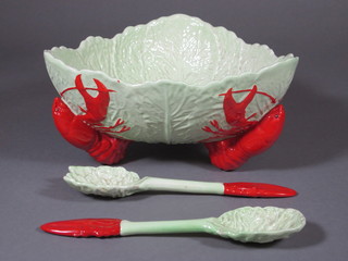A Carltonware leaf shaped salad dish raised on lobster supports together with a pair of salad servers