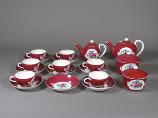 A 19 piece Imperial Russian red ground tea service comprising 2 teapots 4 1/2" and 3", 2 jars and covers 3", 8 saucers - 2 with  chips to rims and 7 cups - 1 cracked, the base with double headed  eagle, bearing St George mark