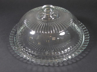 A circular glass cheese dish and cover 13"
