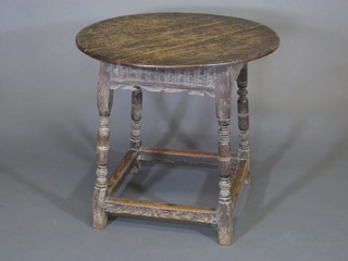 A circular oak occasional table with arcaded decoration raised on  turned and block supports 30"