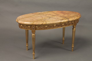 An oval carved giltwood occasional table with pink veined  marble top 37"