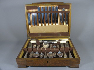 A canteen of silver plated Old English flatware contained in an oak canteen box