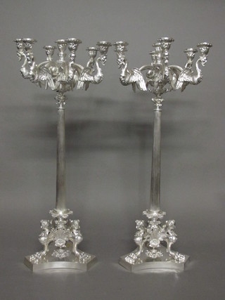 A large and impressive pair of silver plated 5 light candelabrum  with detachable sconces, raised on fluted tapering columns with  triform bases 30"