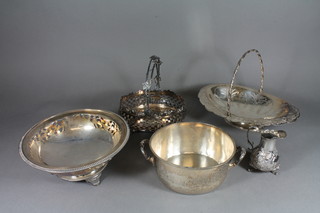 An oval engraved silver plated cake basket with swing handle, a  silver plated twin handled bowl, 2 silver plated baskets and a  cream jug