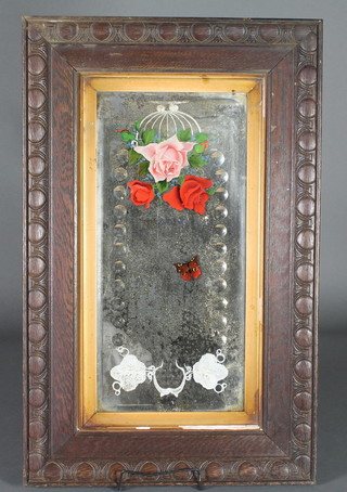 A Victorian rectangular cut and painted glass mirror with floral decorated contained in a carved oak frame 33" x 20"