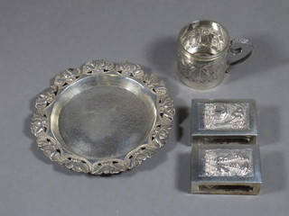 An Eastern white metal dish 4", 2 Eastern embossed white metal match slips and a spirit measure