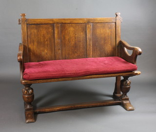 An elm settle with panelled back, raised on bulbous turned  supports with H framed stretcher 48"