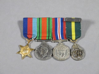 A group of 4 miniature medals comprising 1939-45 Star,  Defence medal, British War medal, George VI Territorial  Efficiency decoration