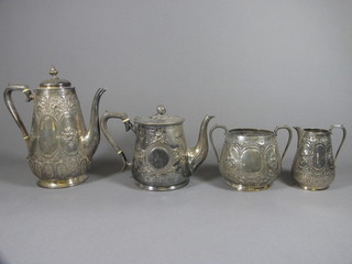 A Britannia metal 4 piece tea/coffee service comprising teapot, coffee pot, sugar bowl and cream jug with embossed engraved  decoration