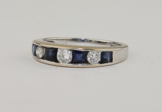 An 18ct white gold half eternity ring set sapphires and diamonds