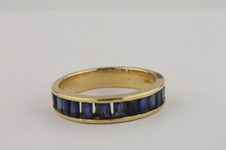 A lady's 18ct gold dress ring set baguette cut sapphires, 1  missing,