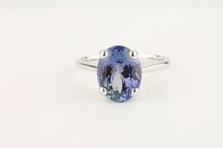 A lady's dress ring set an oval cut tanzanite, approx 3.02ct,  complete with certificate