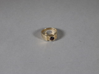 A 9ct gold dress ring set a red stone