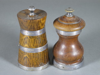 A turned wooden and silver mounted pepper mill Birmingham  1928 and a waisted turned oak and silver mounted pepper mill  Birmingham 1935 with Jubilee hallmark